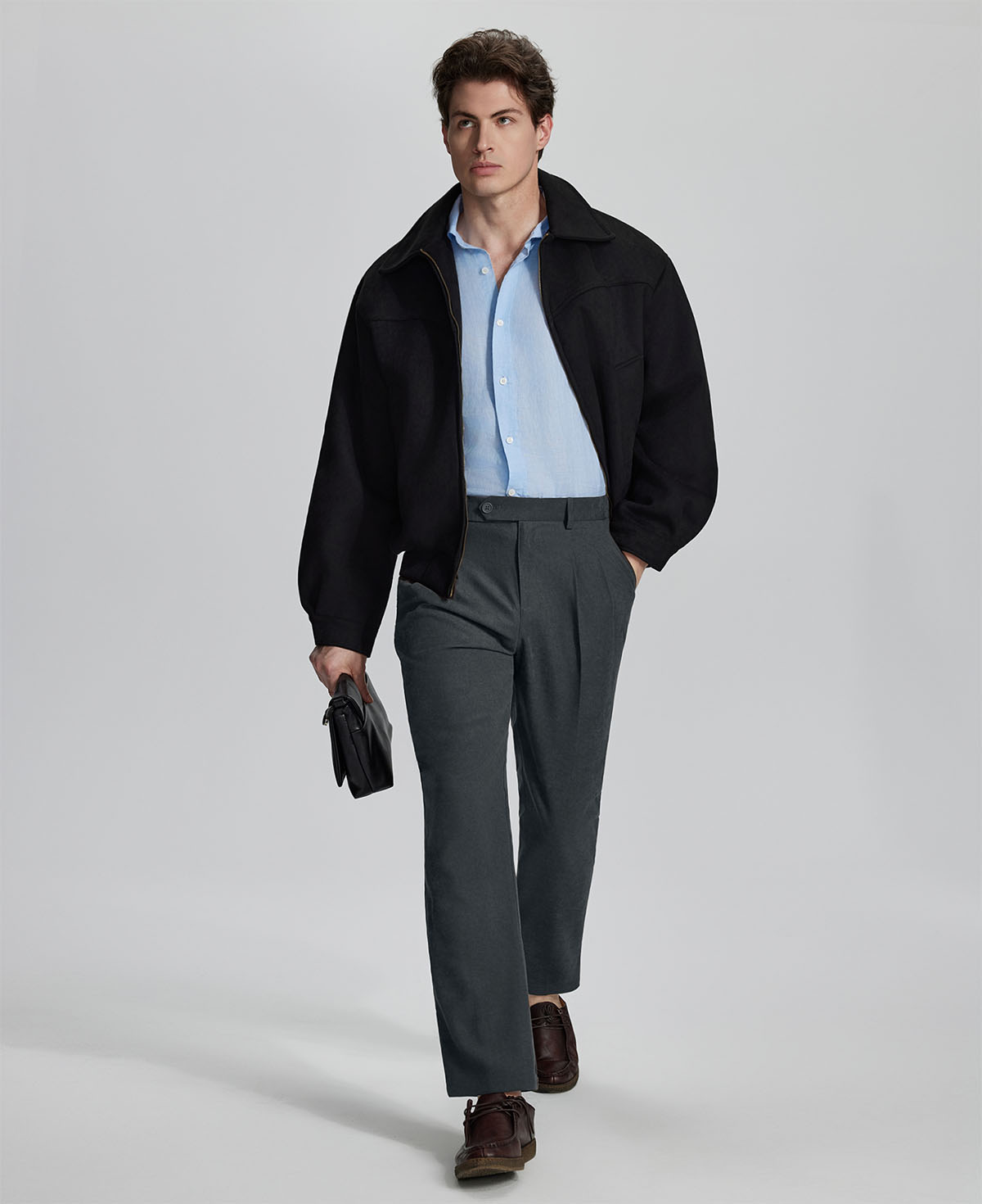 Model in grey blazer, light blue shirt, and Mens Pleated Dress Pants showing smart business casual outfit with regular fit trousers.