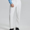 Man in light blue shirt, white Mens Pleated Dress Pants, and brown shoes showcasing regular fit & straight-leg style.