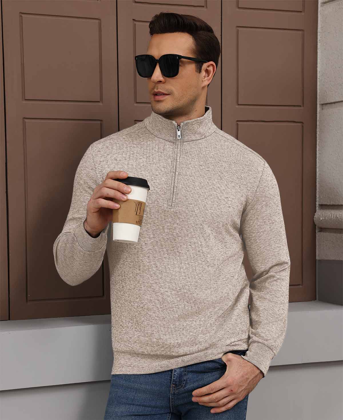 Model holding coffee in apricot Men's Quarter Zip Sweater, comfortable look for light casual settings.