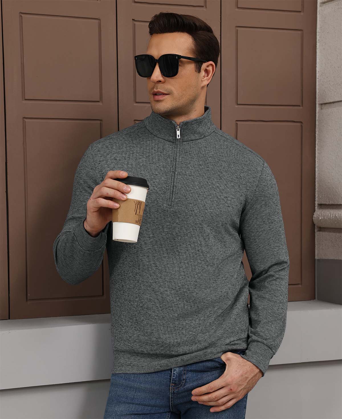 Model holding coffee in grey Men's Quarter Zip Sweater, comfortable look for light casual settings.