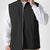 Man in black Men's Softshell Vest ¨C Lightweight Windproof Sleeveless, white long-sleeve tee & khaki pants, casual layered look.