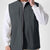Man in dark grey Men's Softshell Vest ¨C Lightweight Windproof Sleeveless, white long-sleeve tee & khaki pants, casual layered look.