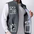 Pockets on dark grey Men's Softshell Vest hold phone, sunglasses, ID, practical storage for daily or outdoor use.