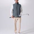 Model wearing light grey Men's Softshell Vest with golf club, ideal lightweight layer for outdoor leisure activities.