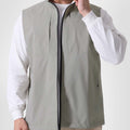 Man in sage green Men's Softshell Vest ¨C Lightweight Windproof Sleeveless, white long-sleeve tee & khaki pants, casual layered look.