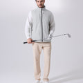Model wearing white grey Men's Softshell Vest with golf club, ideal lightweight layer for outdoor leisure activities.