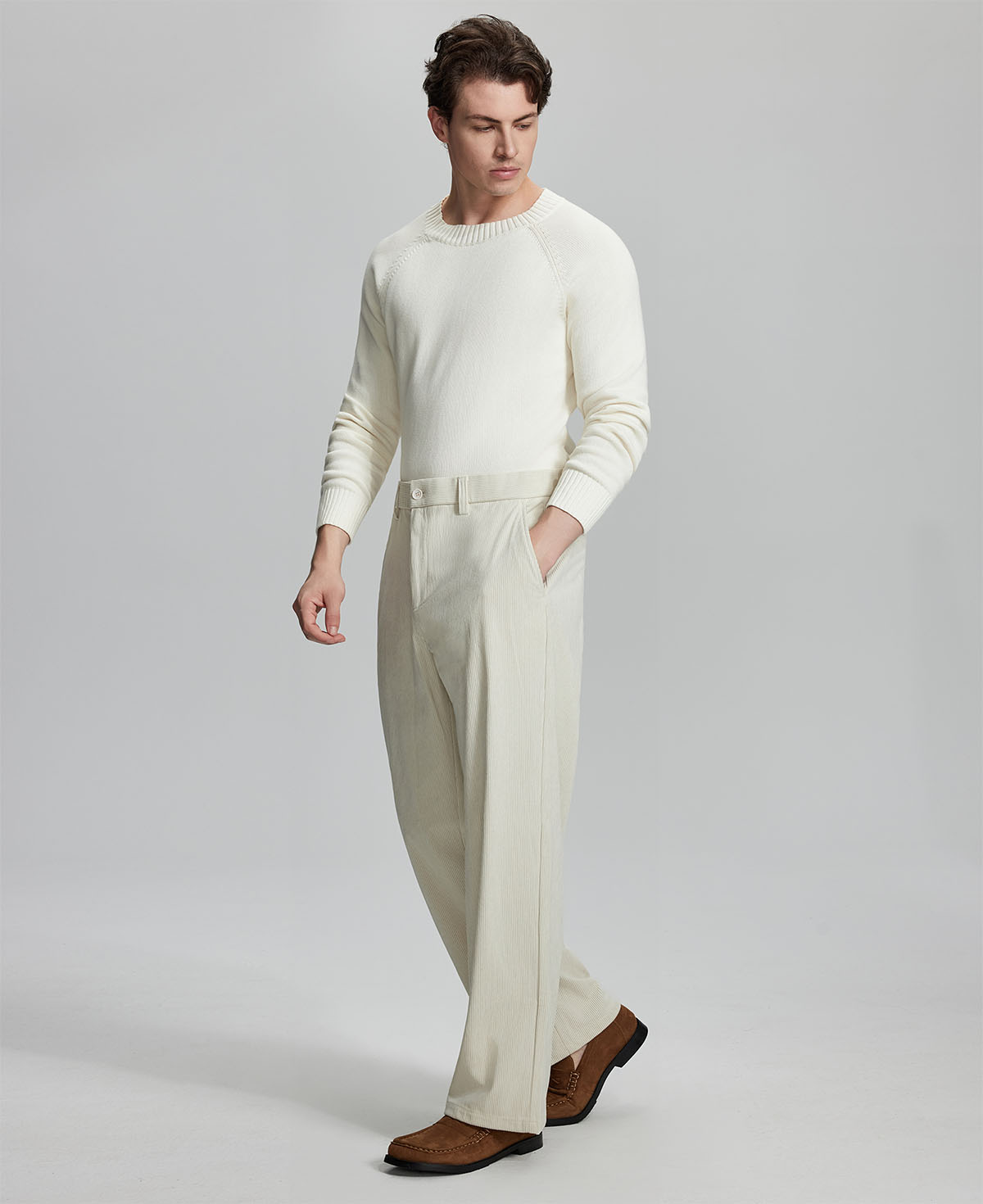 Side view of model wearing sunglasses with apricot wide-leg corduroy pants, highlighting loose fit and style adaptability.