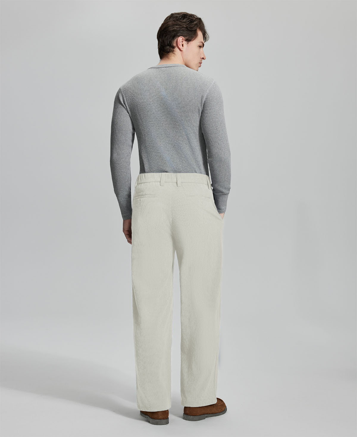 Back view of apricot wide-leg corduroy pants, showing overall silhouette and rear pocket design for comfort and style.