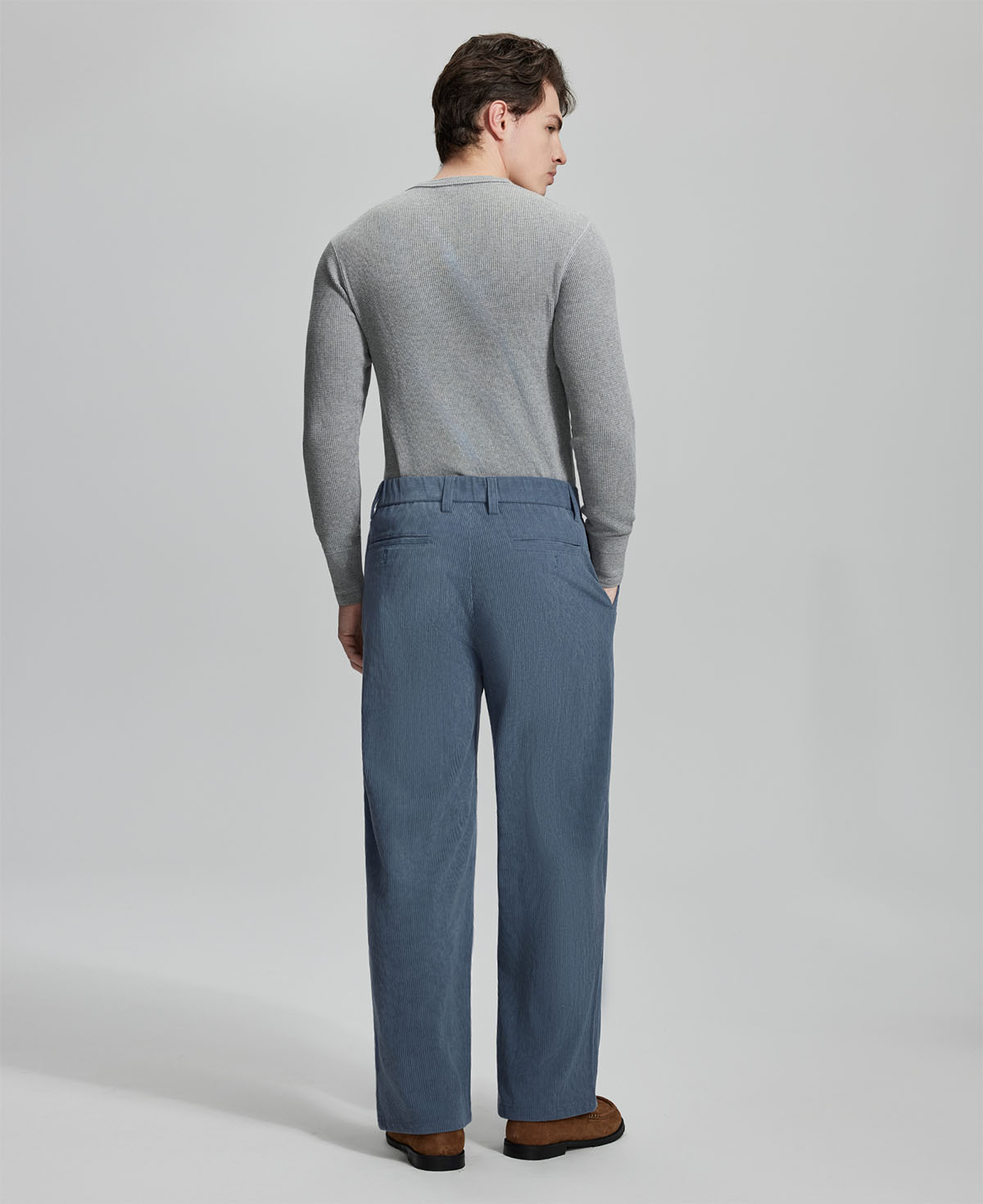 Back view of blue wide-leg corduroy pants, showing overall silhouette and rear pocket design for comfort and style.
