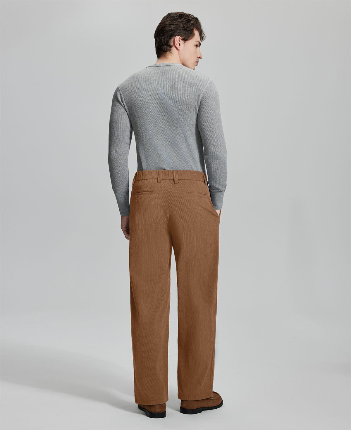 Back view of brown wide-leg corduroy pants, showing overall silhouette and rear pocket design for comfort and style.