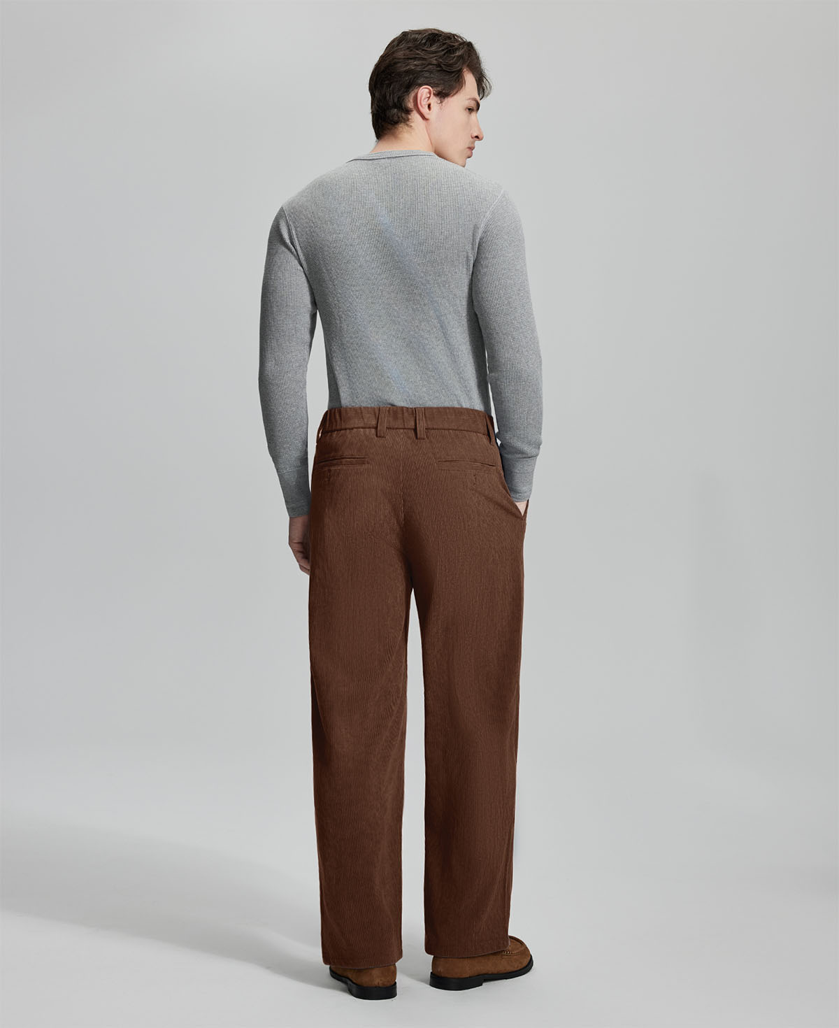 Back view of coffee wide-leg corduroy pants, showing overall silhouette and rear pocket design for comfort and style.