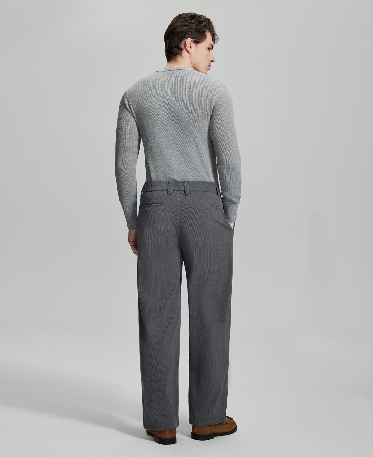 Back view of dark grey wide-leg corduroy pants, showing overall silhouette and rear pocket design for comfort and style.