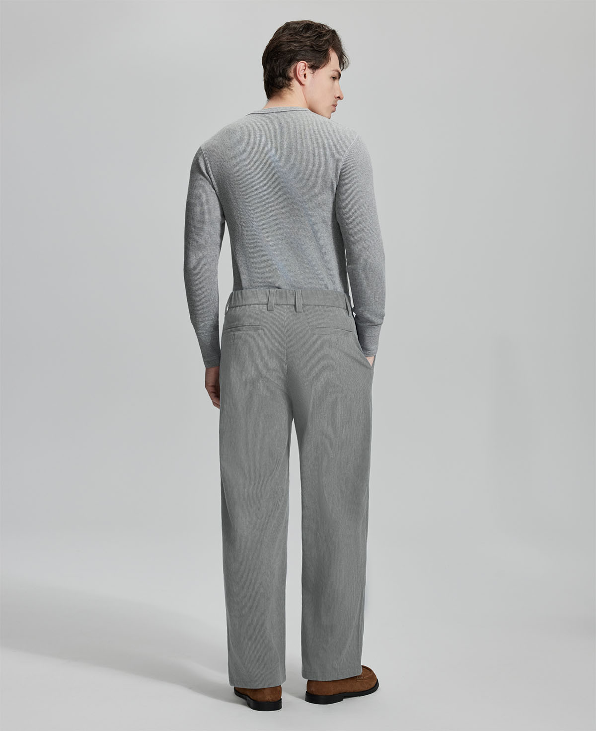 Back view of light grey wide-leg corduroy pants, showing overall silhouette and rear pocket design for comfort and style.