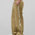 Man in khaki baggy wide leg sweatpants, side view, showing stripe detail and loose fit. White sneakers.