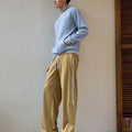 Man in khaki baggy wide leg sweatpants, showing both side and front views while standing.
