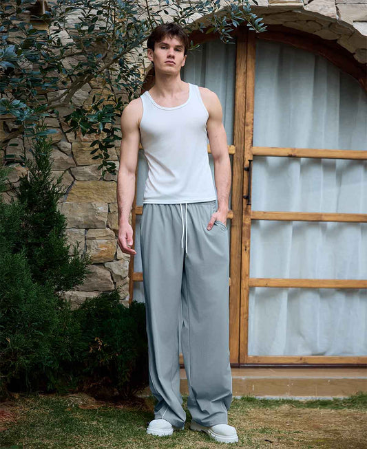 Man in lake blue baggy wide leg sweatpants, showing both side and front views while standing.