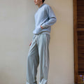 Man in light grey baggy wide leg sweatpants, showing both side and front views while standing.