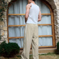 Adjustable drawstring at the hem of light khaki baggy wide leg sweatpants, showing stitching details and fabric texture.