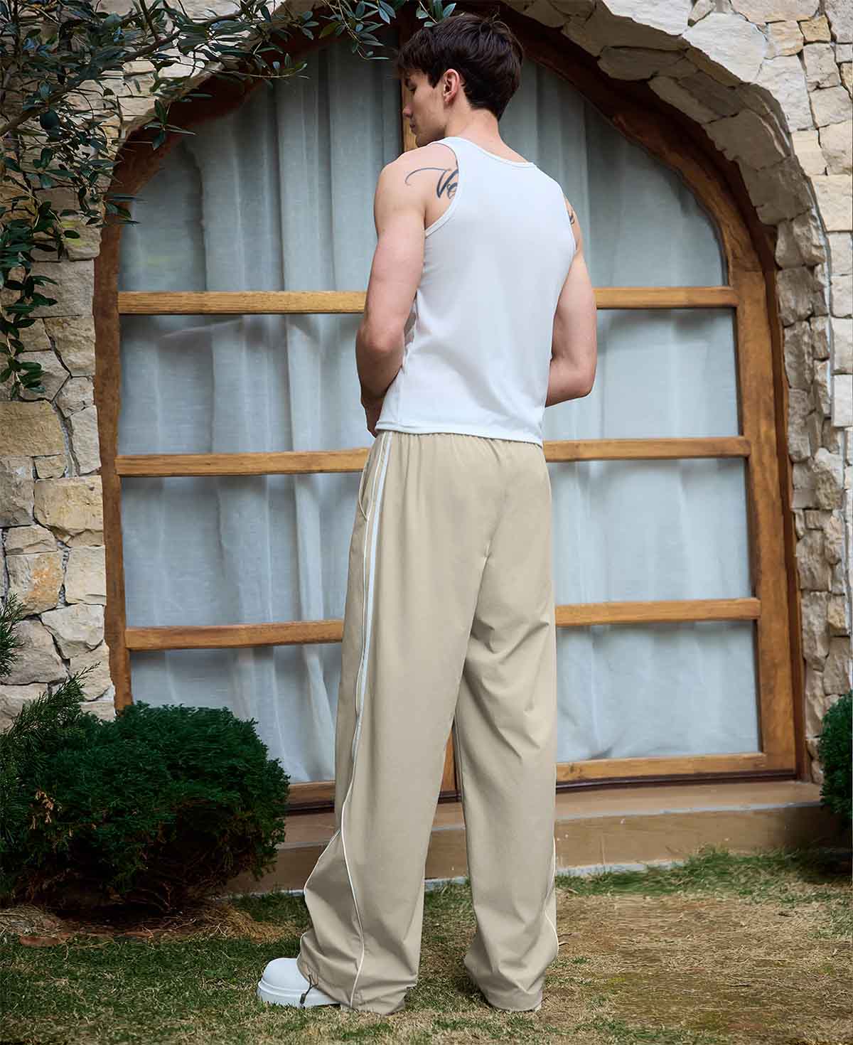Adjustable drawstring at the hem of light khaki baggy wide leg sweatpants, showing stitching details and fabric texture.