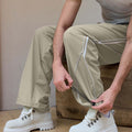 Custom fabric for men's light khaki baggy wide leg sweatpants, windproof exterior, breathable and quick-dry interior.