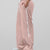 Man in pink baggy wide leg sweatpants, side view, showing stripe detail and loose fit. White sneakers.