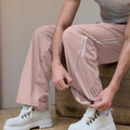 Adjustable drawstring at the hem of pink baggy wide leg sweatpants, showing stitching details and fabric texture.